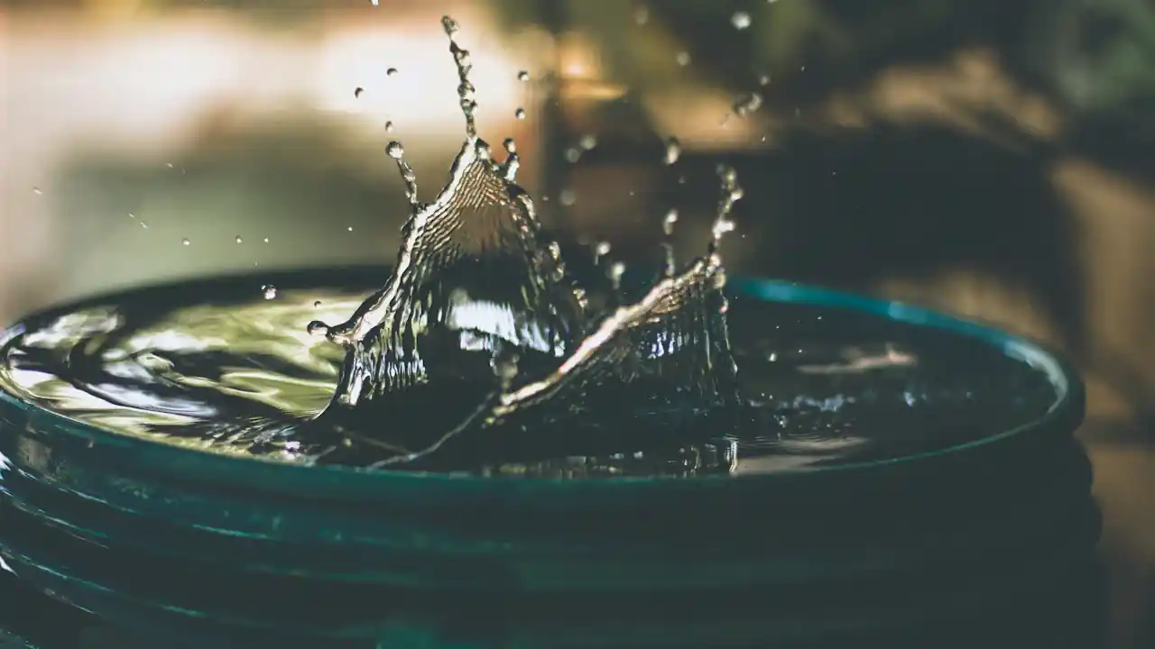 Water splashing into a bucket